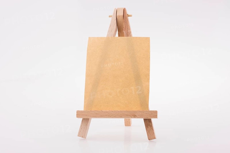 Brown color notepaper on a painting tripod on white background