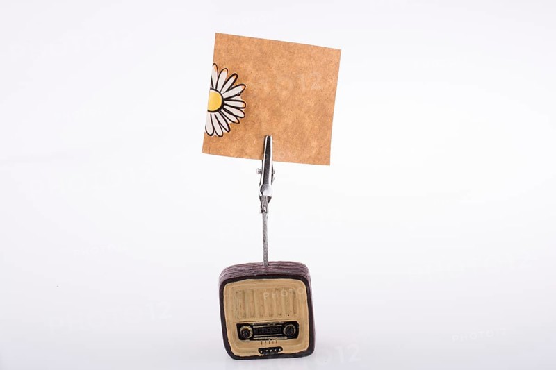 Note paper attached to an retro styled radio on a white background
