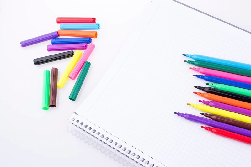 Colorful felt-tip pens on a notebook