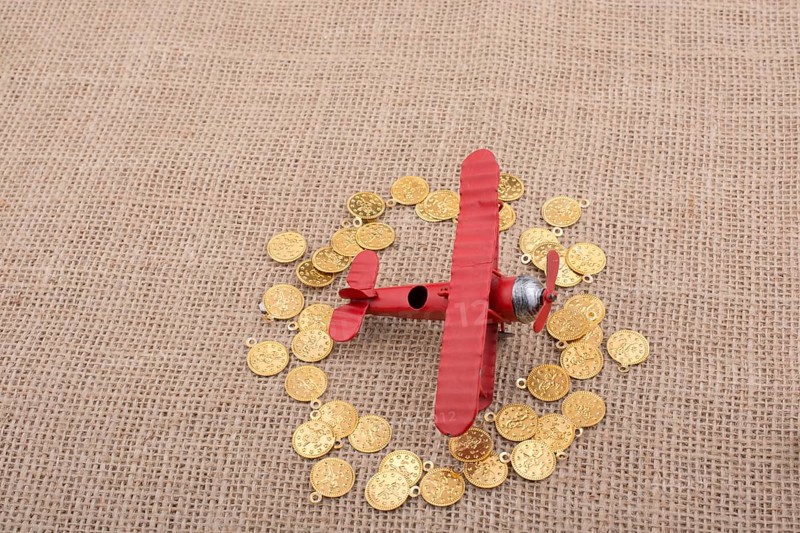 Fake gold coins around the retro model airplane