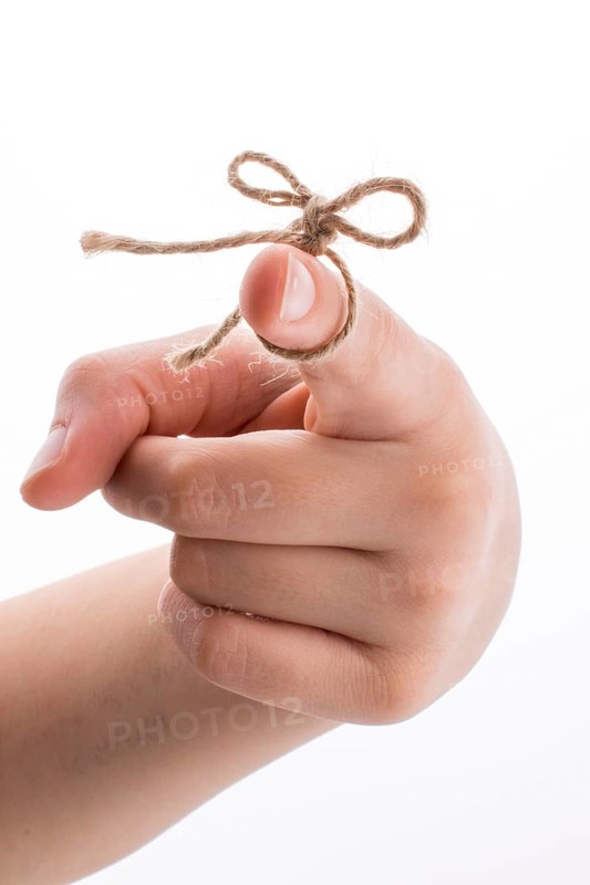 Hand tied with a thread like a ribbon on a white background