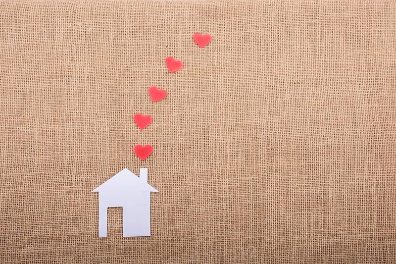 Heart shape coming out of chimney of paper house
