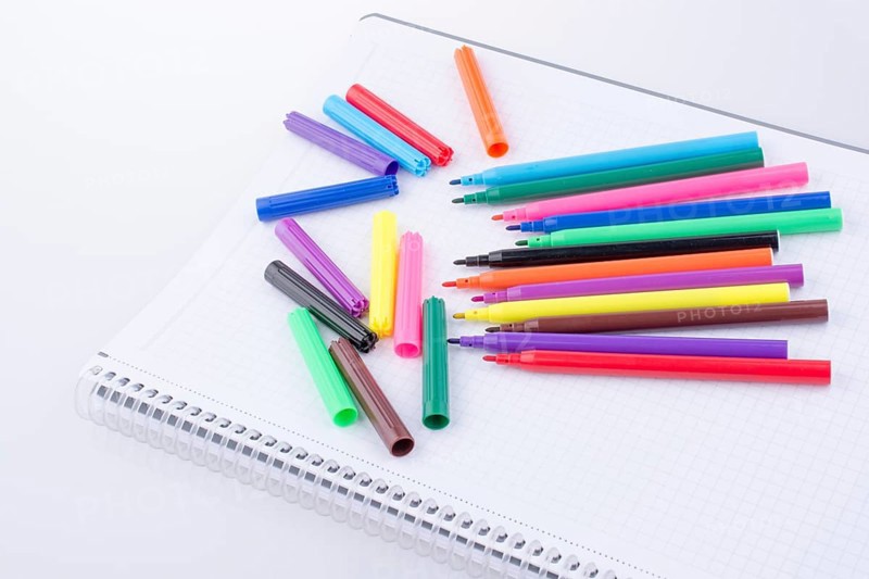 Colorful felt-tip pens on a notebook