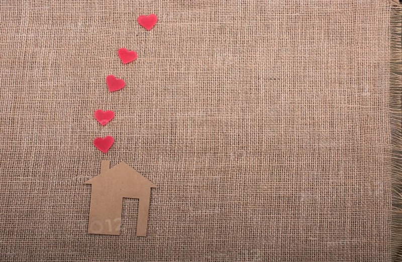 Heart shape coming out of chimney of paper house