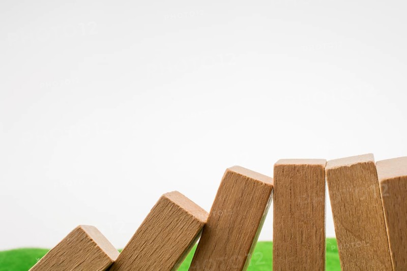 Wooden dominos on green grass