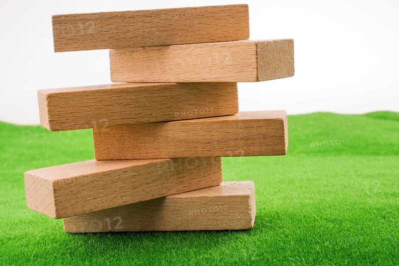 Wooden dominos on green grass