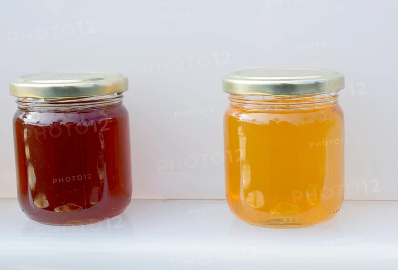 Glass jar of full of fresh honey with lid