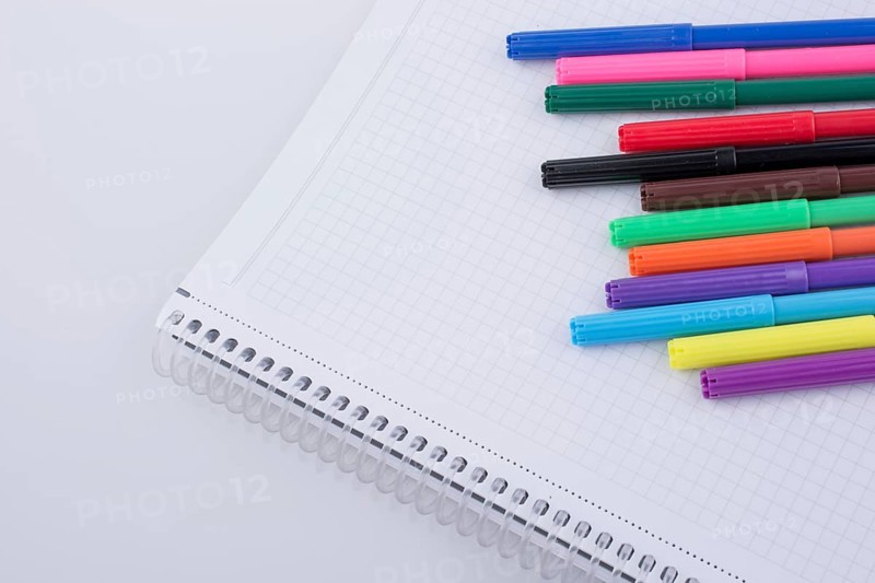 Colorful felt-tip pens on a notebook