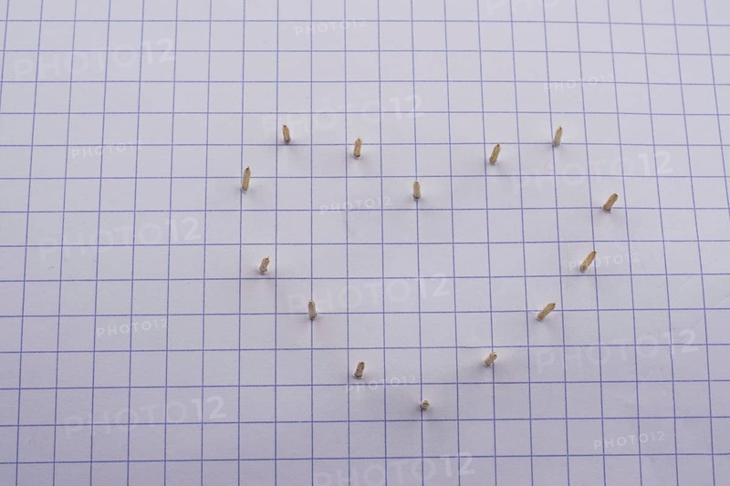 Nails make hole on paper forming a heart shape