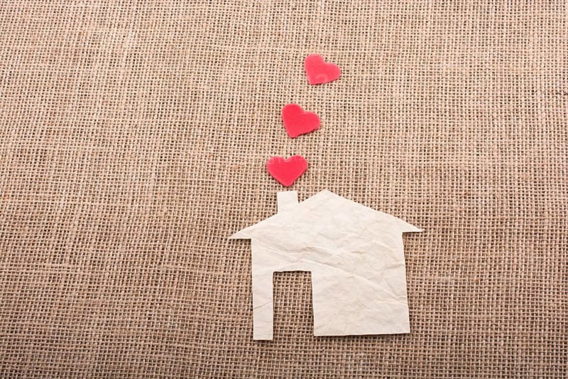 Heart shape coming out of chimney of paper house