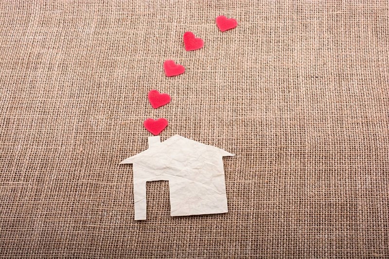 Heart shape coming out of chimney of paper house
