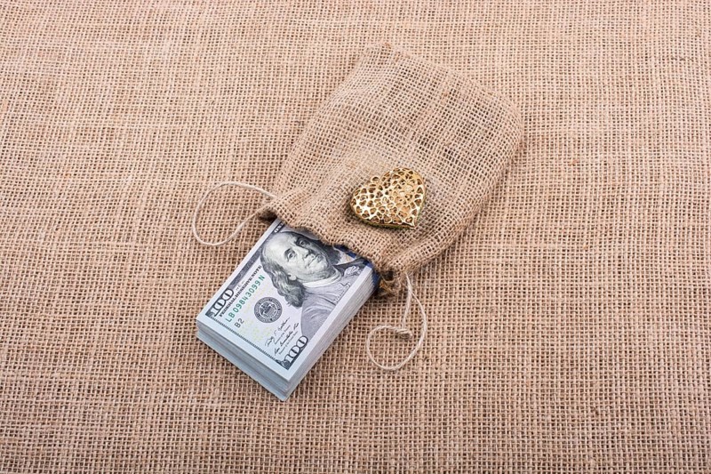 Heart icon bundle of US dollar placed on a linen canvas