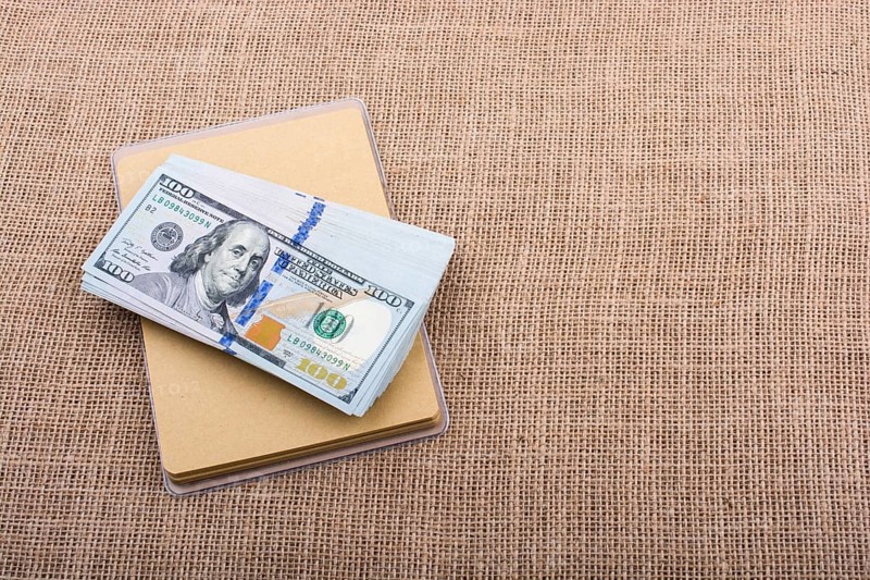 Banknote bundle of US dollar placed on a linen canvas