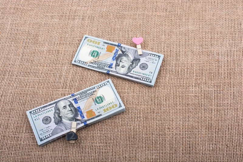 Heart icon bundle of US dollar placed on a linen canvas