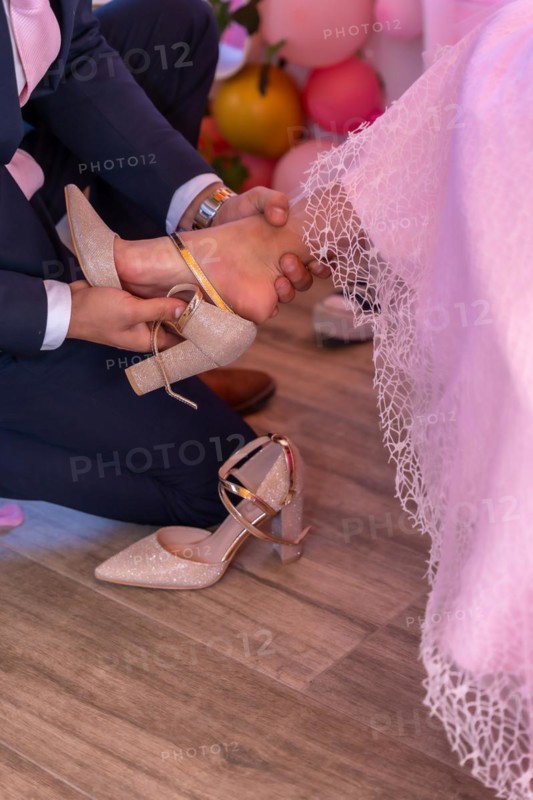 Father putting the shoes on his daughter on her 15th birthday