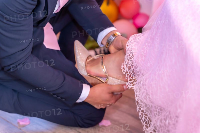 Father putting the shoes on his daughter on her 15th birthday