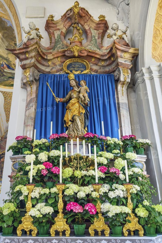Side altar with figure of the Virgin Mary and floral decoration