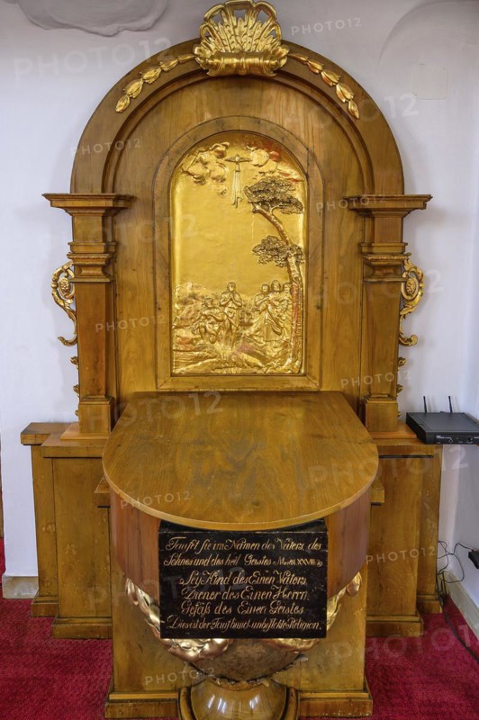 Baptismal font with metal relief