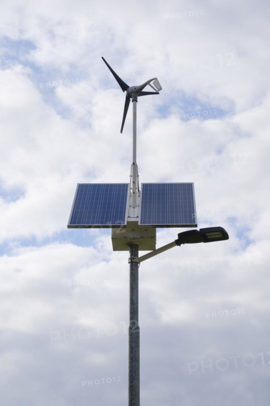 Street lamp with solar panels and small wind turbine