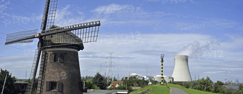 The windmill Scheldedijkmolen and cooling towers of the Doel Nuclear Power Station along the river Scheldt at Kieldrecht