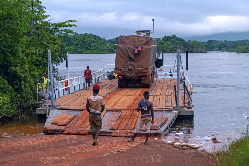 Truck on ferry boat crossing the Essequibo river in the rainy season along the Linden-Lethem dirt road