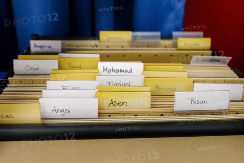 Card index box in a classroom with first names from all over the world