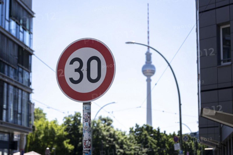 A speed 30 sign stands in the foreground of the TV Tower in Berlin