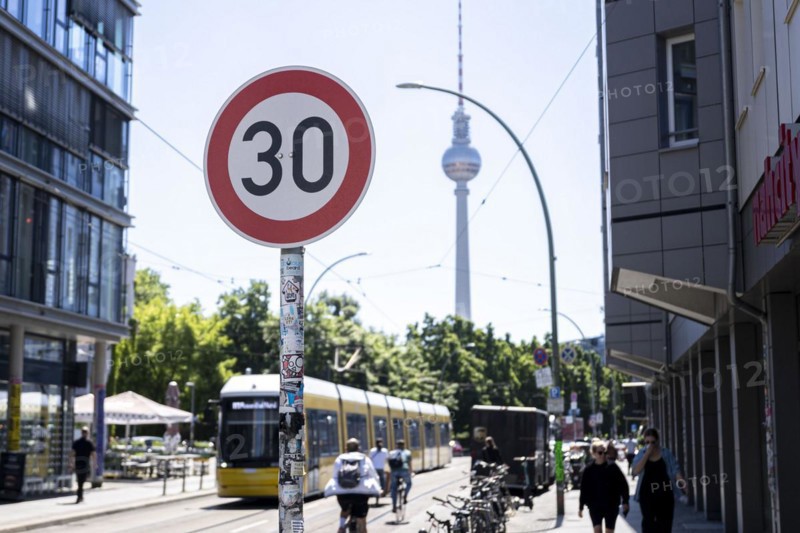 A speed 30 sign stands in the foreground of the TV Tower in Berlin