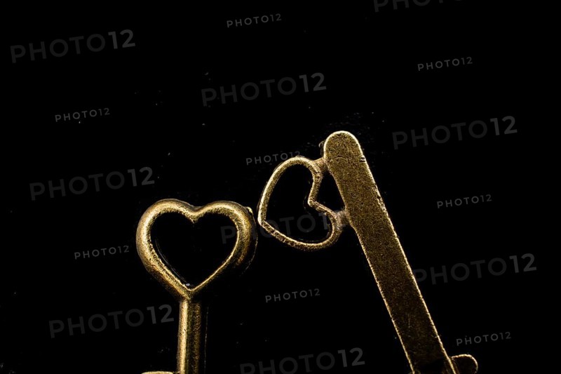 Heart shaped retro metal keys on dark background