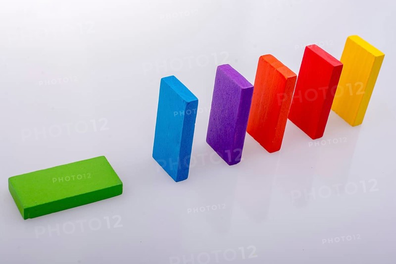 Colorful Domino Blocks in a line on a white background