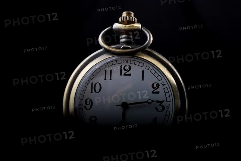 Retro style pocket watch on a dark background