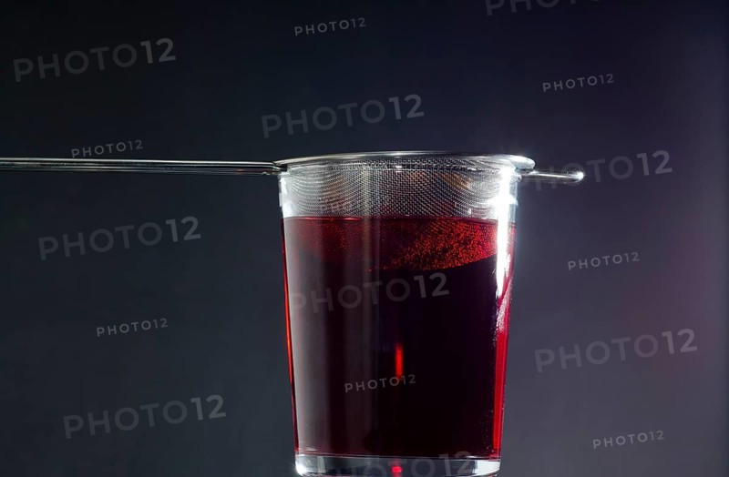 Drinking Glass with Strainer of Red Tea