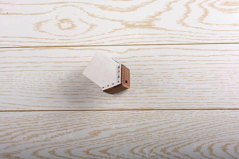 Little model house and on a parquet background