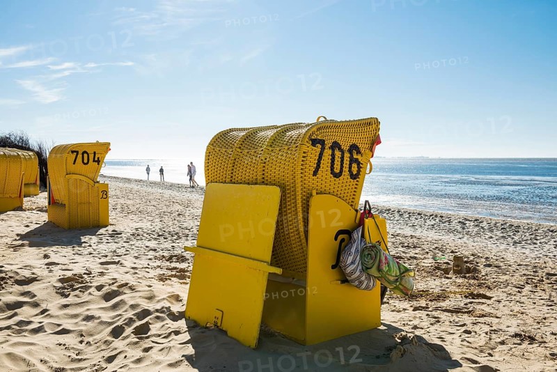 Yellow beach chairs and mudflats