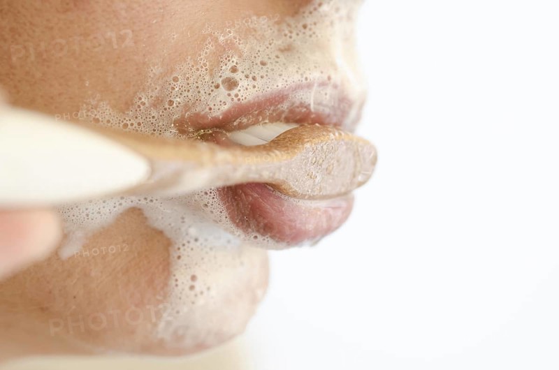 Woman Brushing the Teeth with a Toothbrush