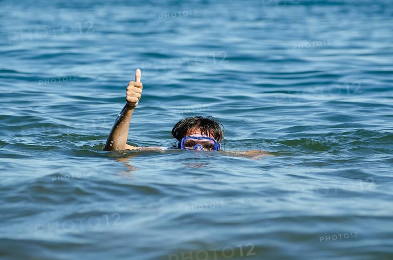 Woman with Diving Mask in the Water and Showing the Thumb Up
