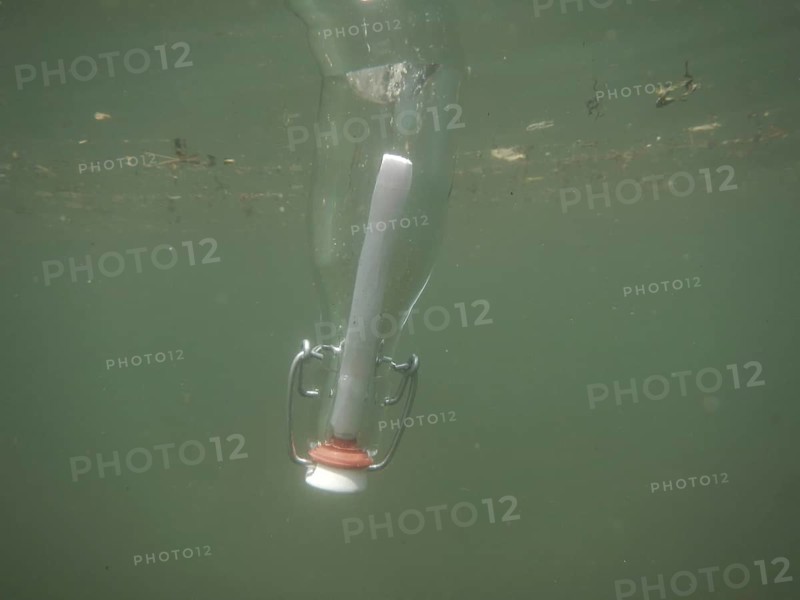 Message in a bottle and floating underwater