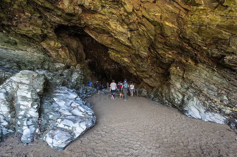 Tourists walk the fabled Merlins Cave
