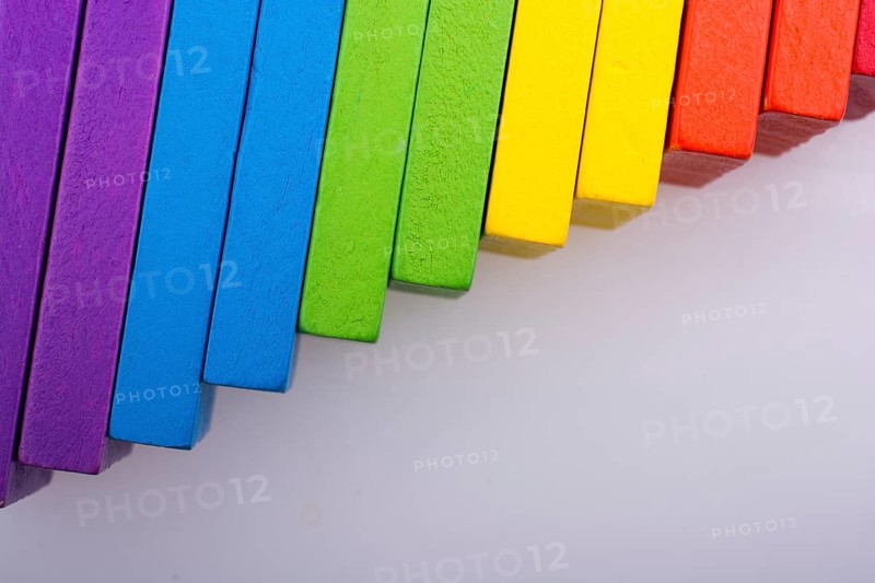 Colorful Domino Blocks in a line on a white background