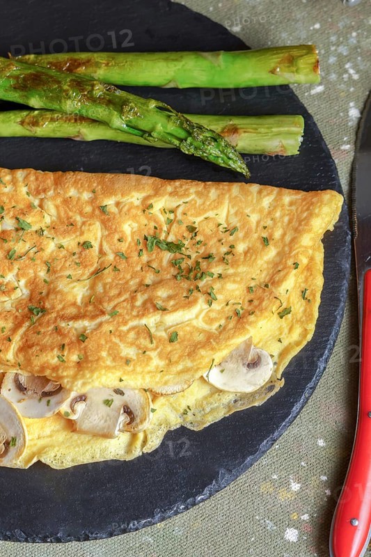 Mushroom omelette with wild asparagus on a slate