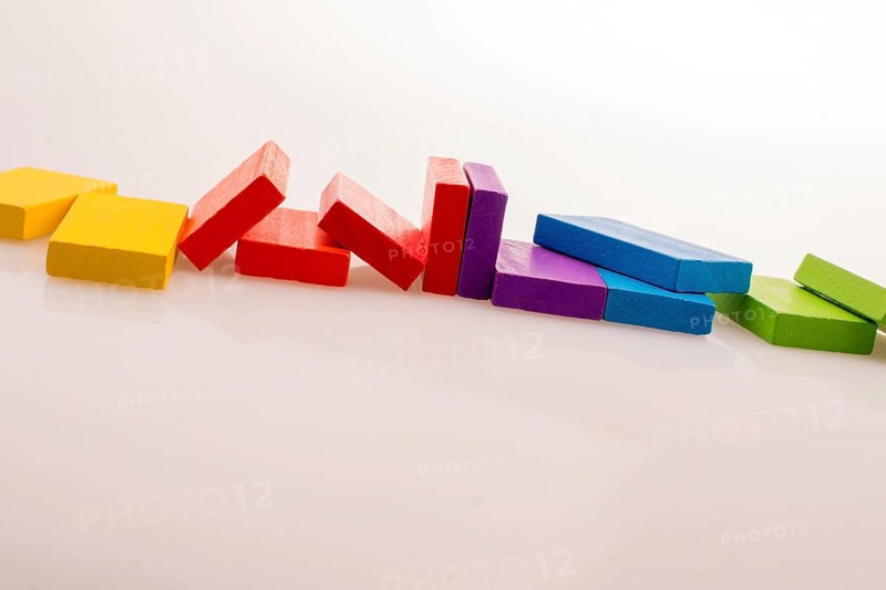 Colorful Domino Blocks in a line on a white background