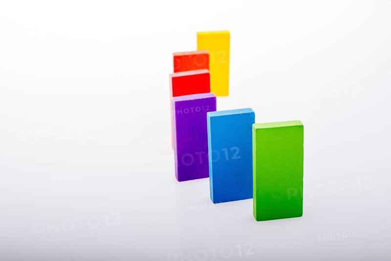 Colorful Domino Blocks in a line on a white background