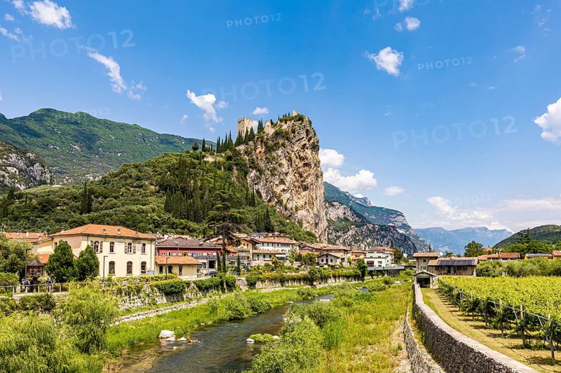 Town view of Arco with the Sarca River and the ruins of Arco Castle