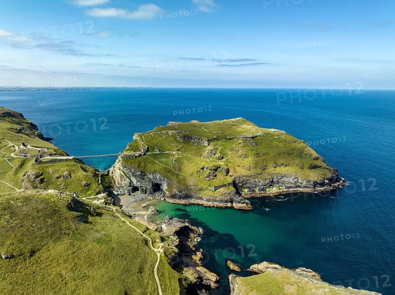 Aerial view of the rugged coastline on the Celtic Sea with the Tintagel Peninsula and the ruins of Tintagel Castle
