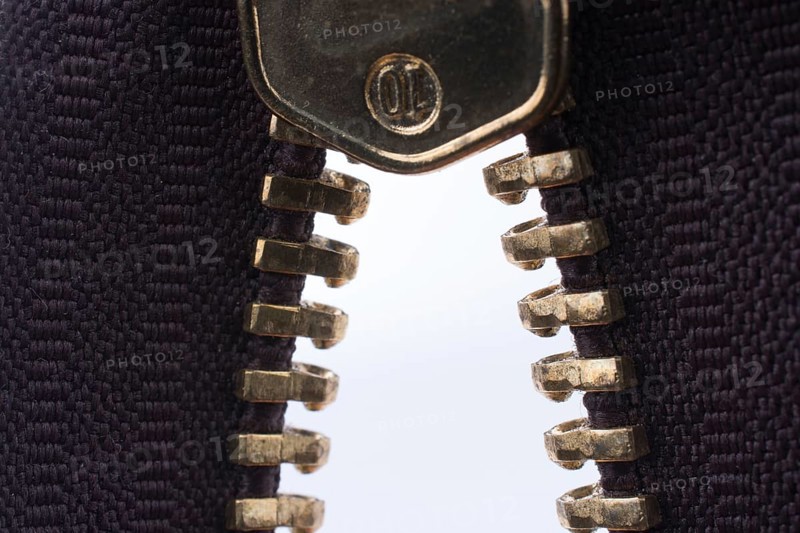 Close up or macro of a brown zipper on white background