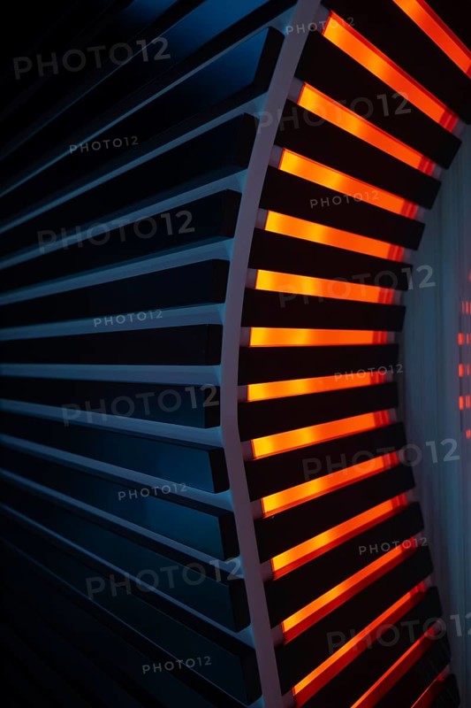 Illuminated Orange Stripes on a Modern Column in Switzerland