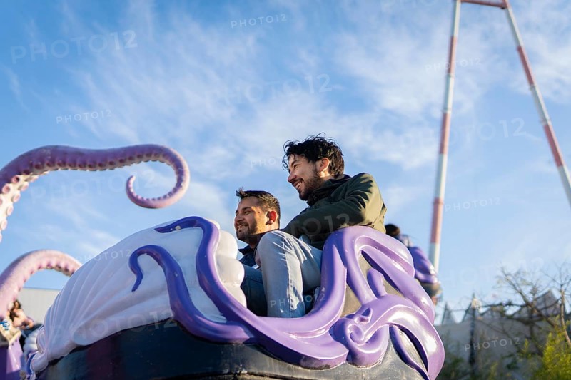 Couple of latin friends having fun in an amusement park