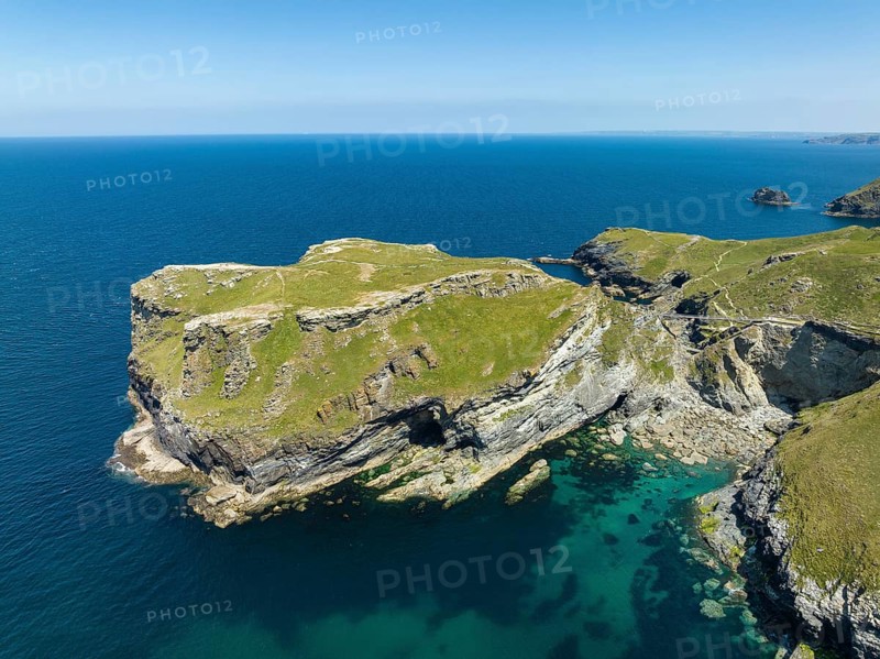 Aerial view of the rugged coastline on the Celtic Sea with the Tintagel Peninsula and the ruins of Tintagel Castle