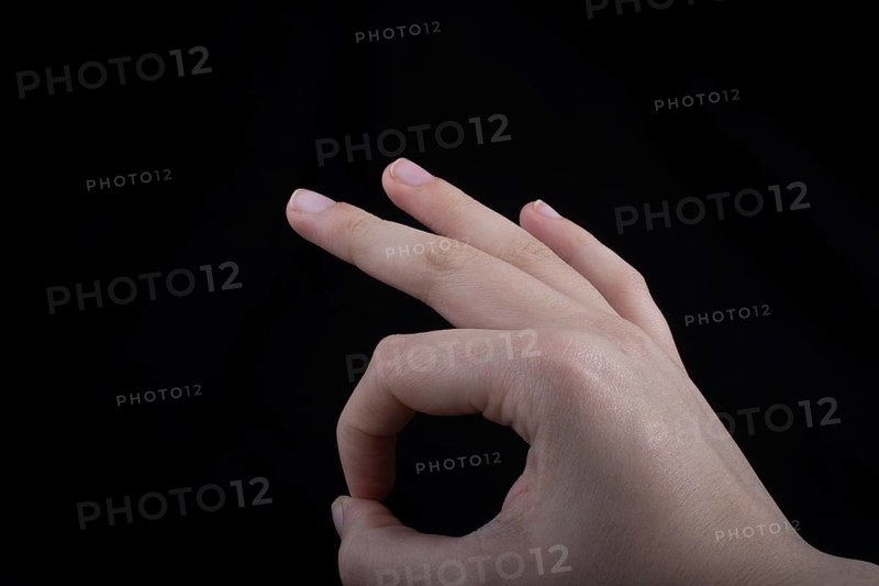 Hand gesturing sign ok okay agree on black background
