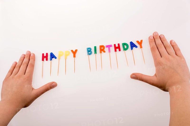 Hand and color candles on sticks write the words happy birthday